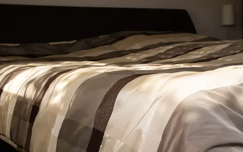 Bezogenes Doppelbett im Morgenlicht